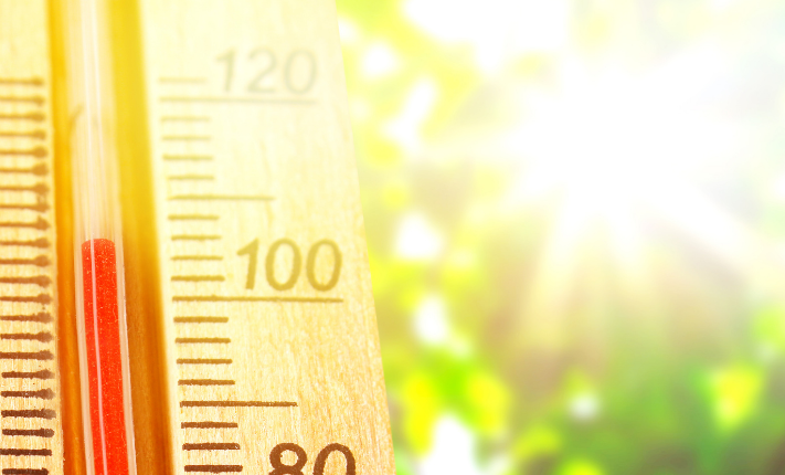 Image of an outdoor thermometer showing outside air temperature in the summer