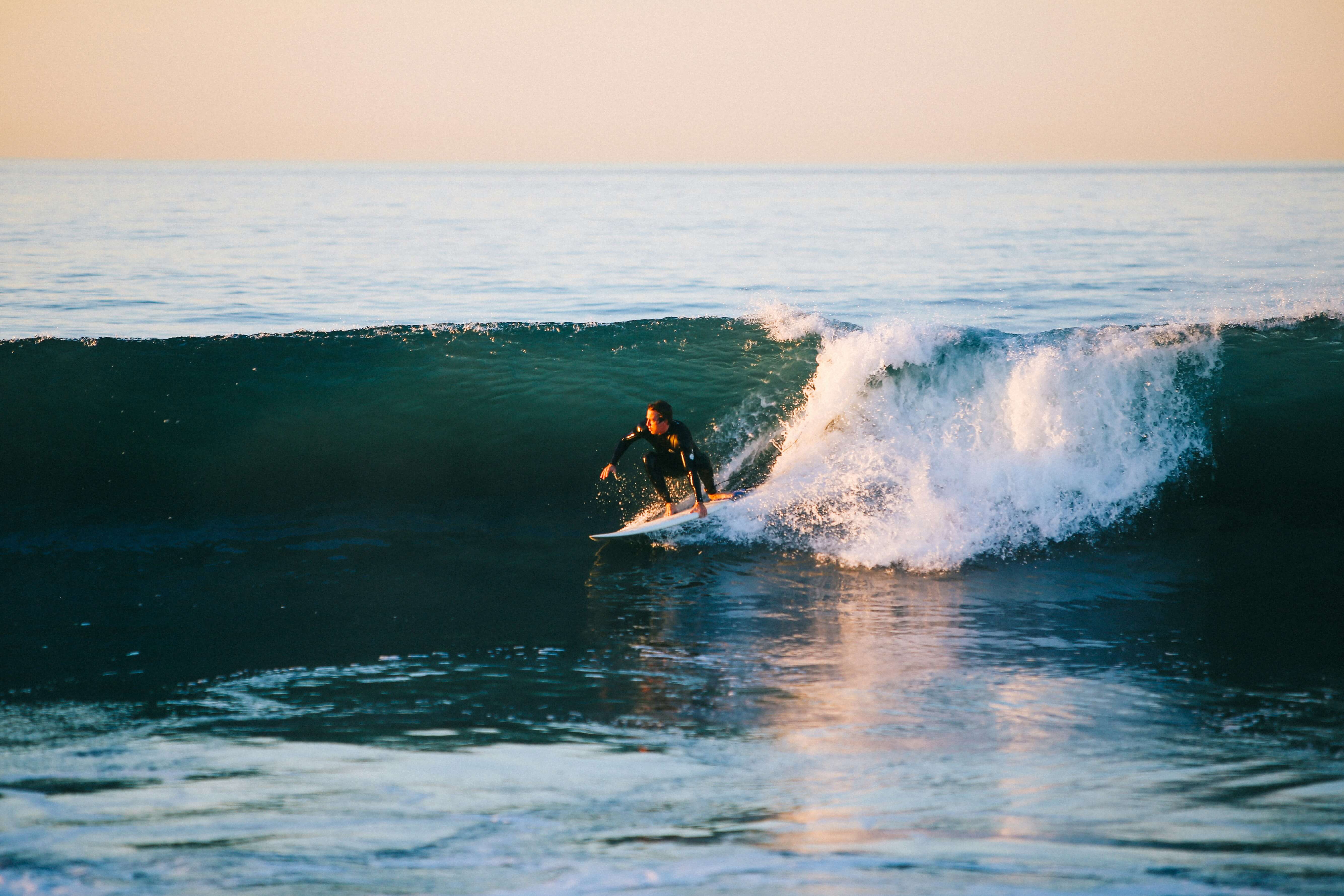 a surfer riding a wave after reading a surf report