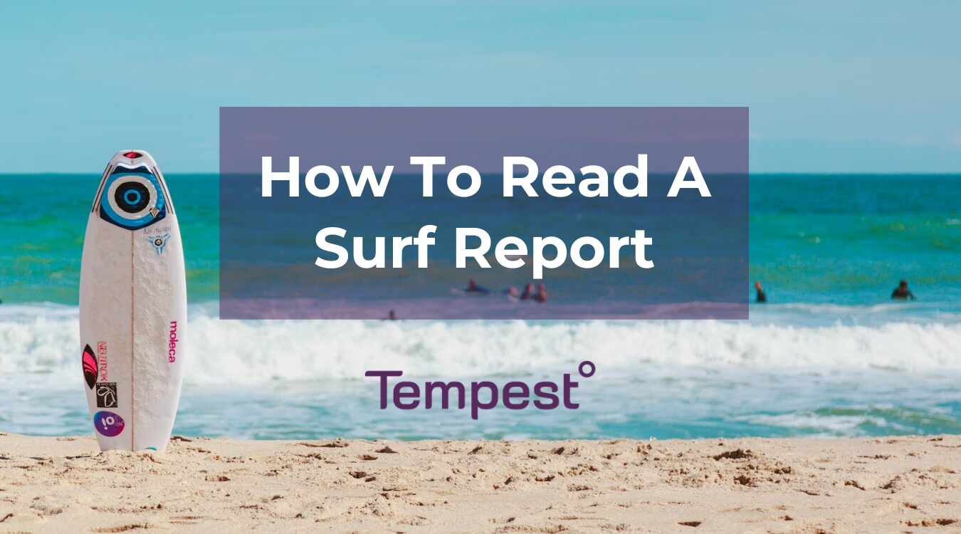 a surf board in the sand as people are surfing after reading a surf report