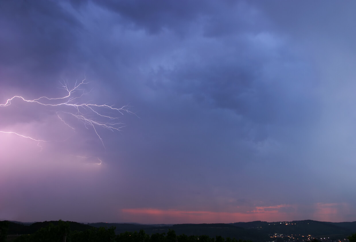 sheet lightning spreading over a rural area